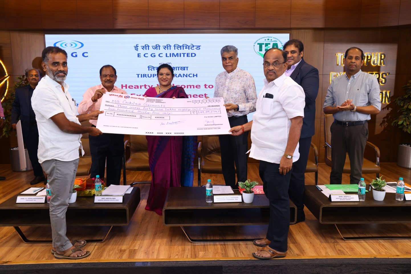 Image for Padmashree Dr. A Sakthivel, Ex-Director, ECGC Ltd & Honorary Chairman, Tirupur Exporter’s Association and General Manager, Smt. Arpita Sen handing a cheque of ₹3,49,89,234/- to policy holder M/s GOKILA GARMENTS of Tirupur branch .