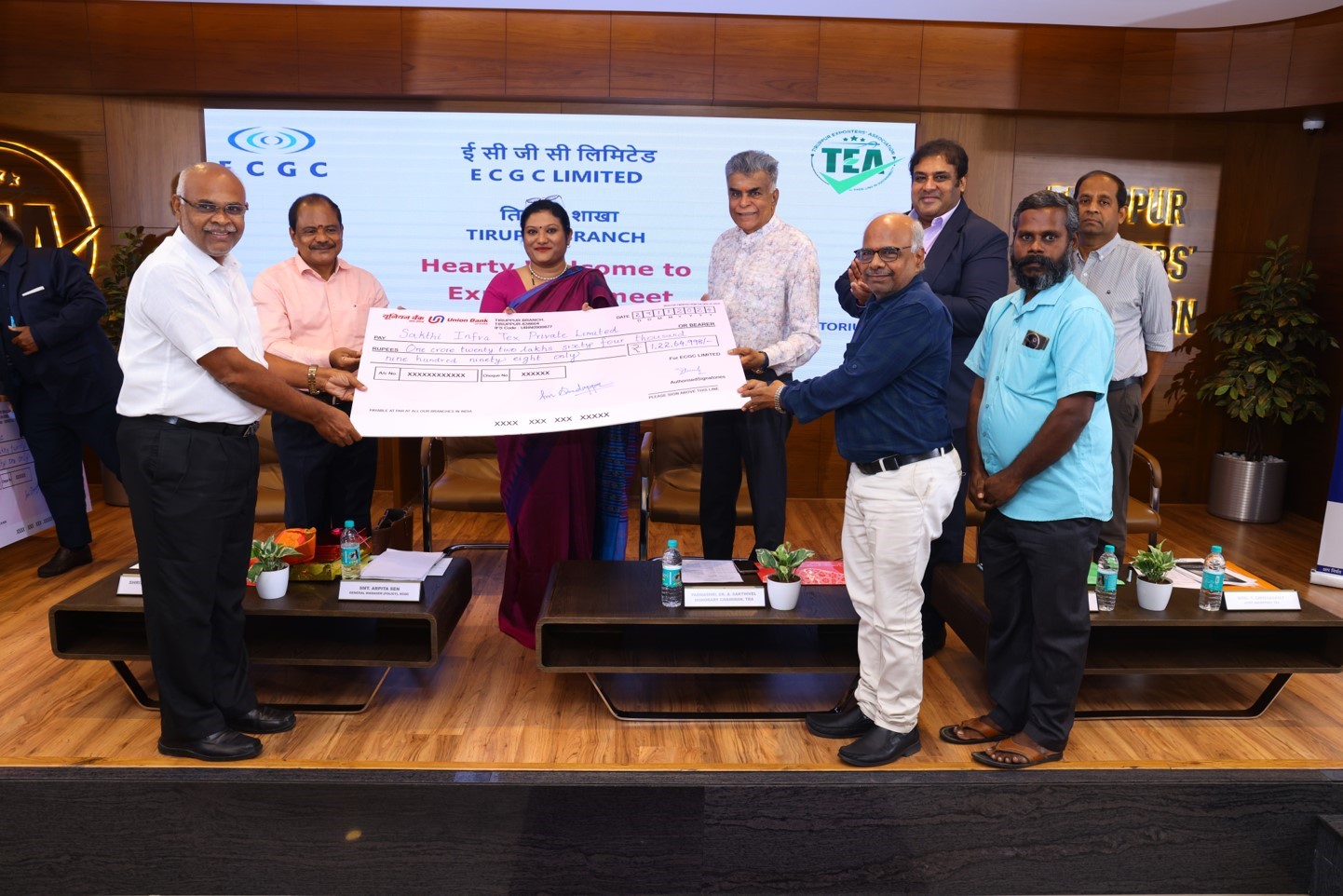 Image for Padmashree Dr. A Sakthivel and Arpita Sen handing over a cheque to a policyholder in Tirupur.
